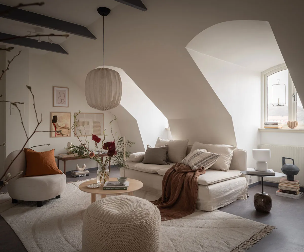 Minimalist living room featuring neutral colors and textured furniture, with a cozy ambiance created by soft lighting and com