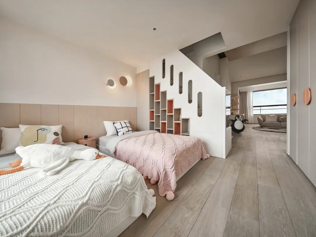 A modern Scandinavian bedroom with white walls, hardwood floors, and white bedding with black and white accents.