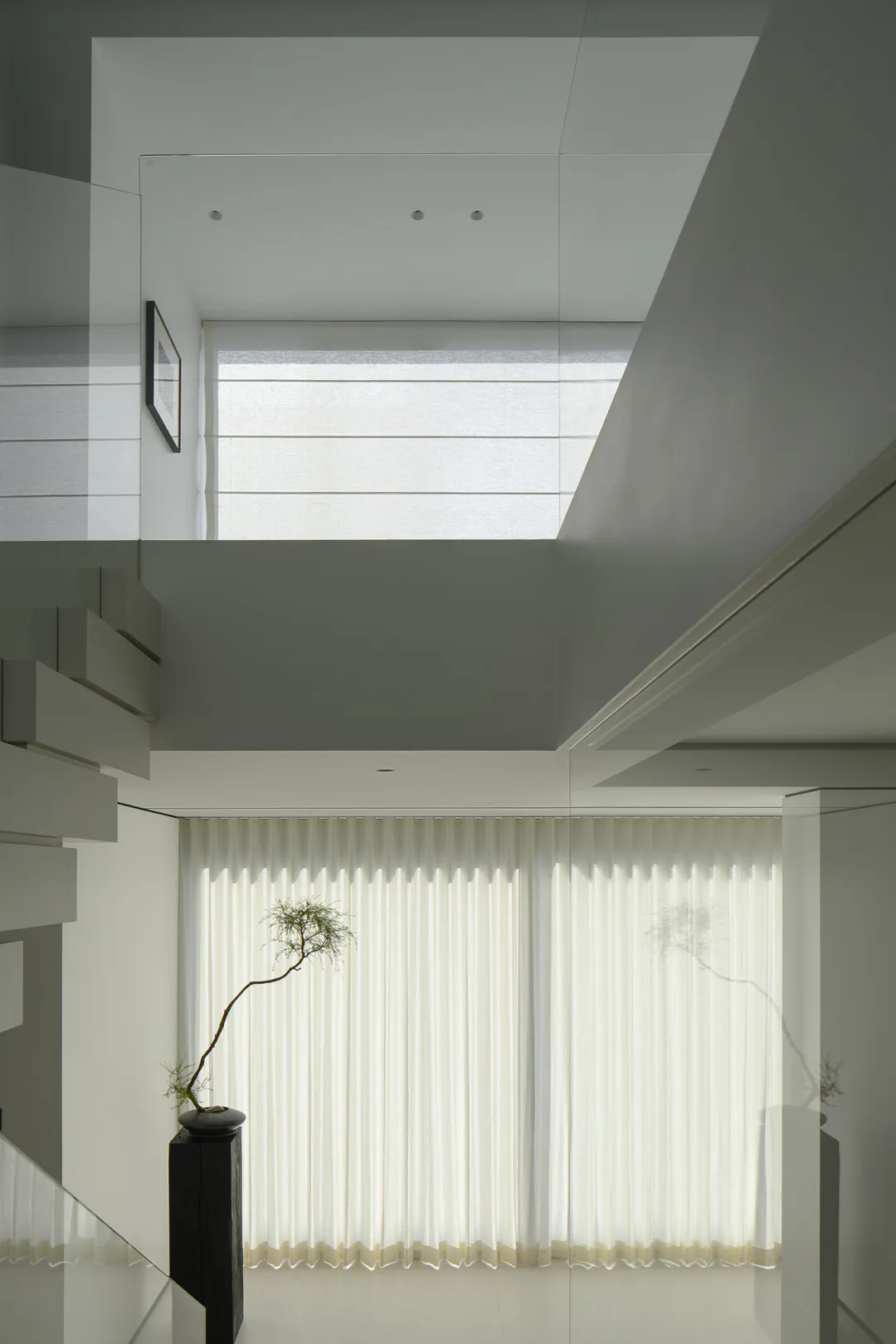 Modern minimalist architecture featuring transparent glass walls and panels.
