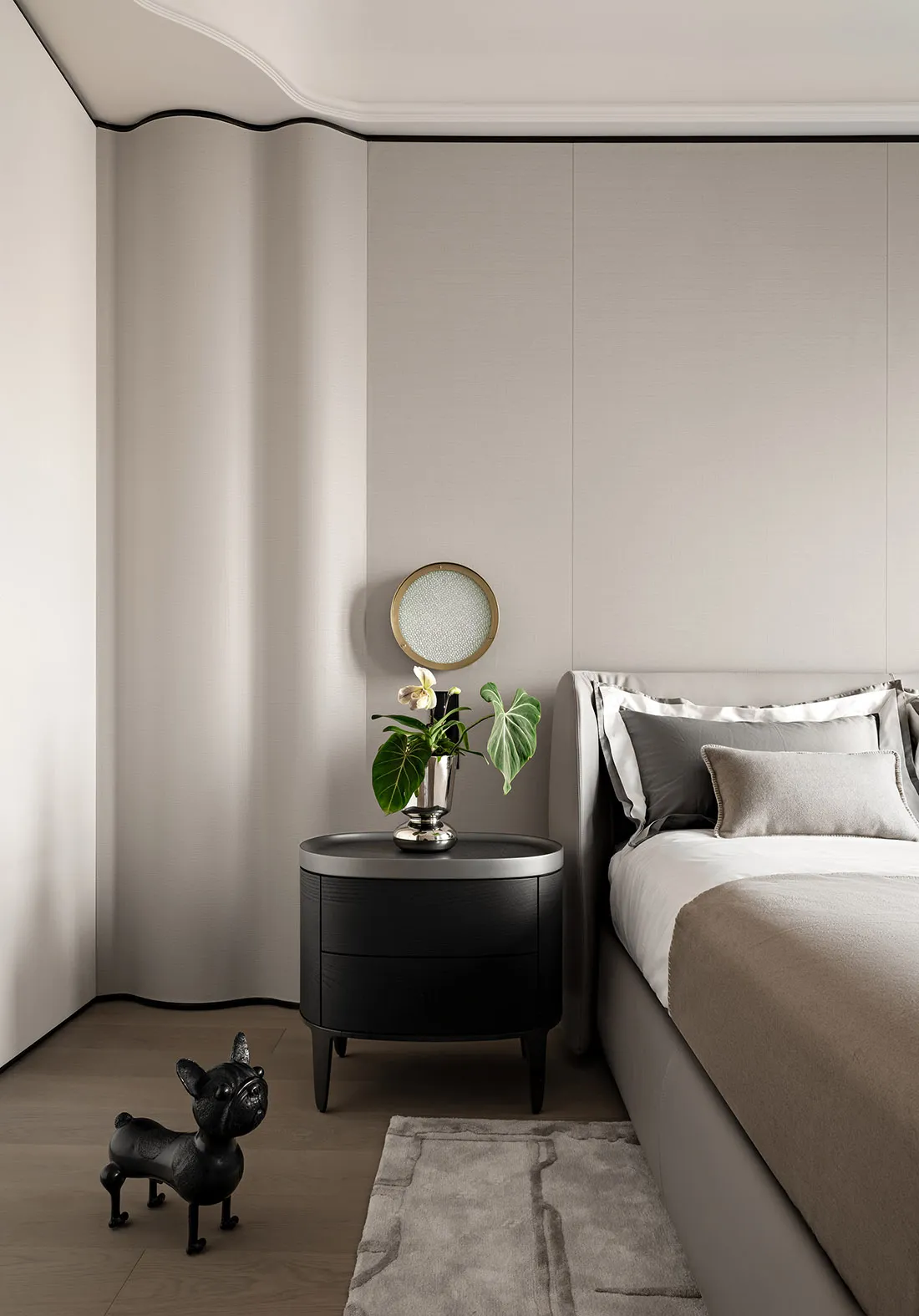 A modern minimalist bedroom with neutral tones, showcasing a sleek bed and smooth textures.