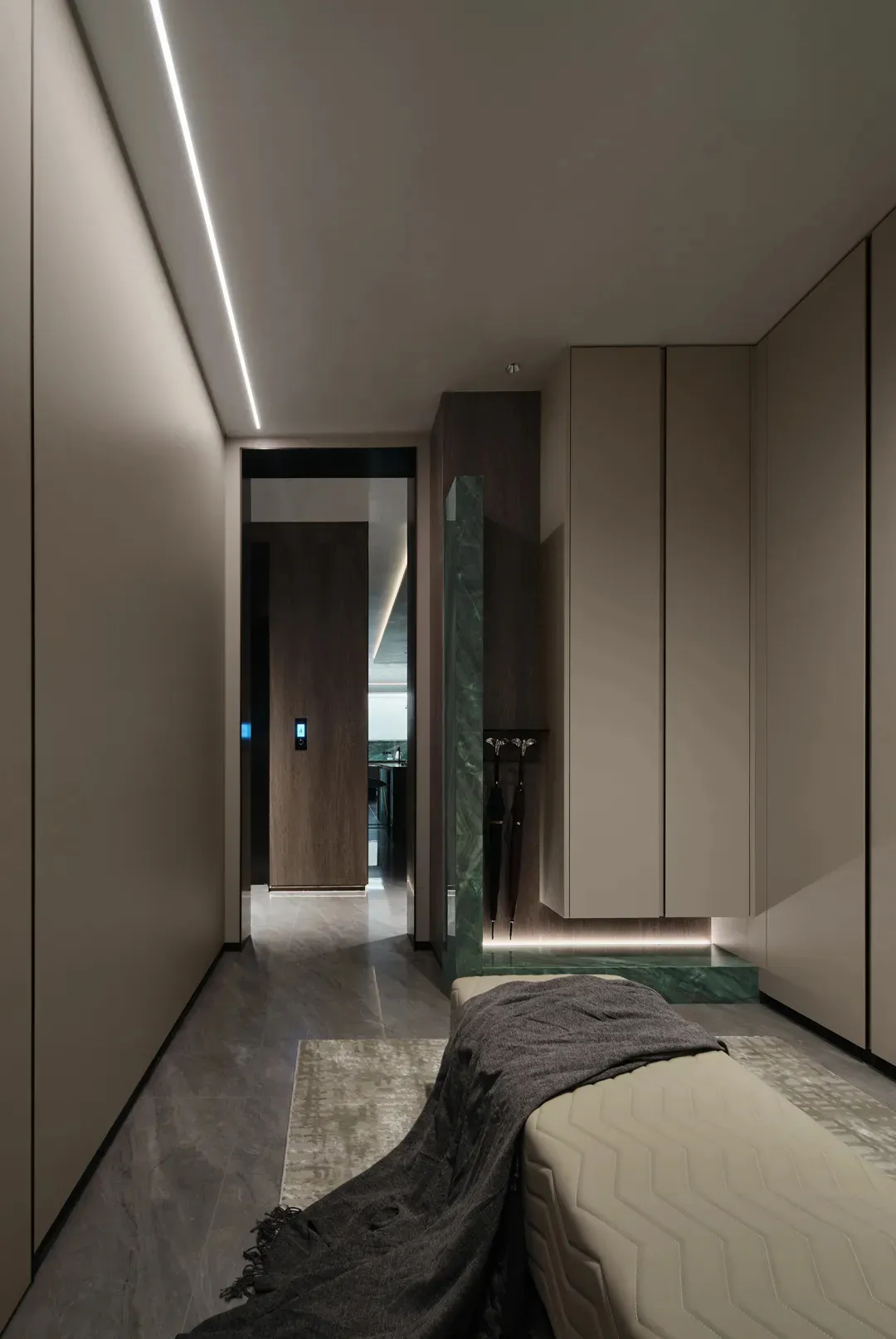 Marble-finished bedroom with minimalist design and a bed.