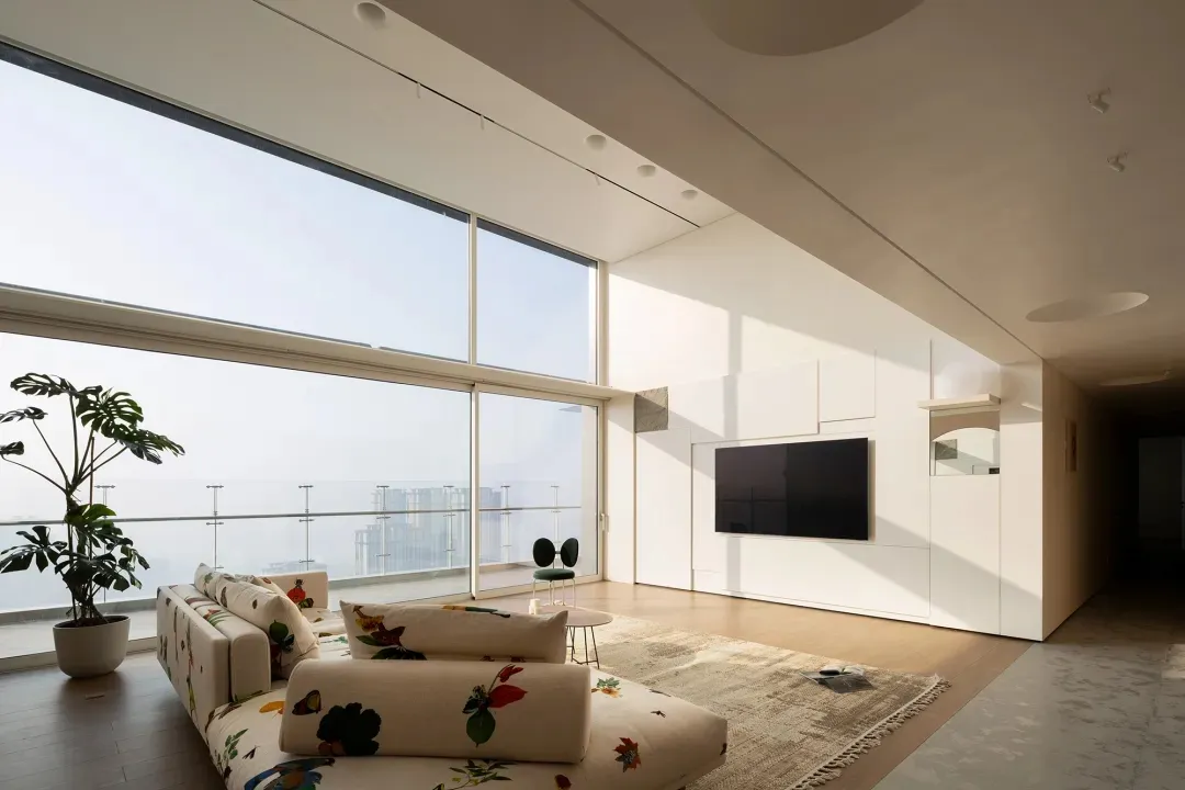 Modern industrial living room featuring large glass windows.