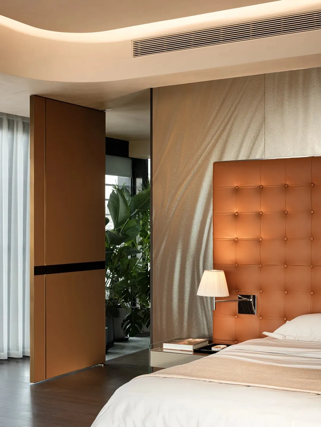 Modern bedroom with textured wall covering, minimalist design, and sleek, open concept layout.