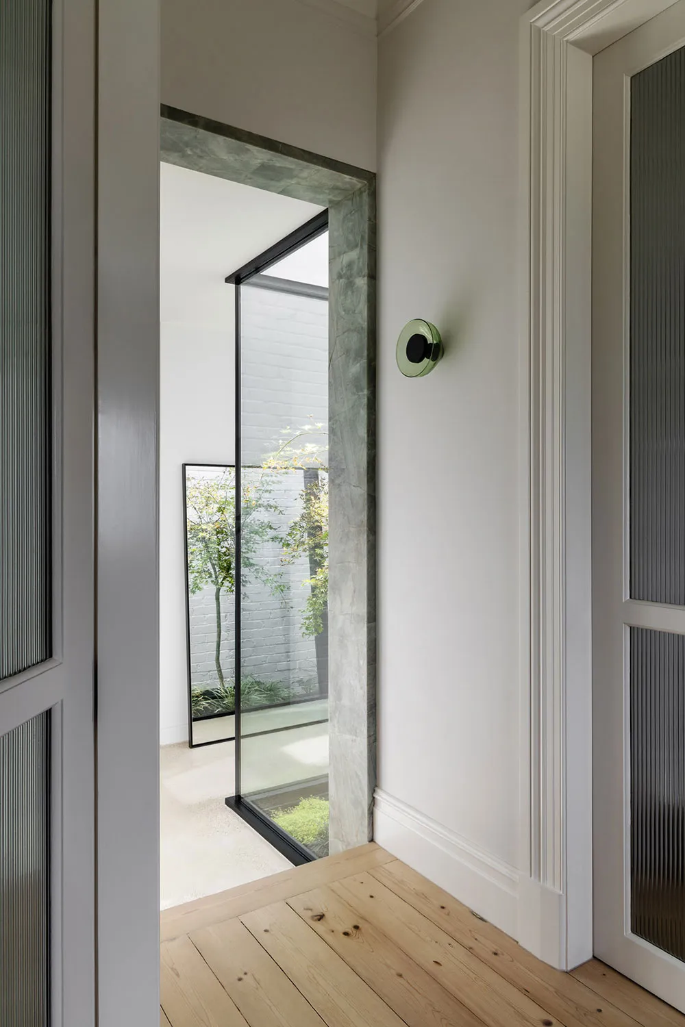 A minimalist interior design with marble accents and a brightly lit space.