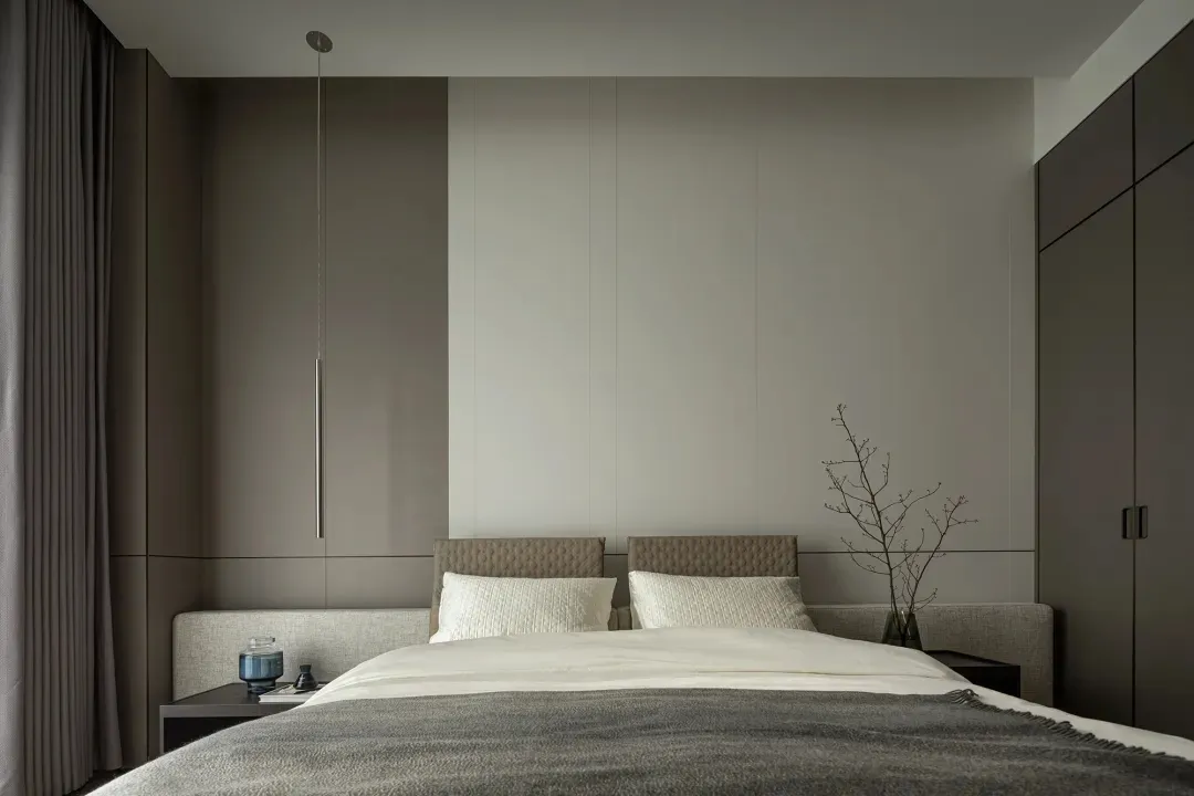 Modern, minimalist bedroom featuring a textured headboard and bedding.