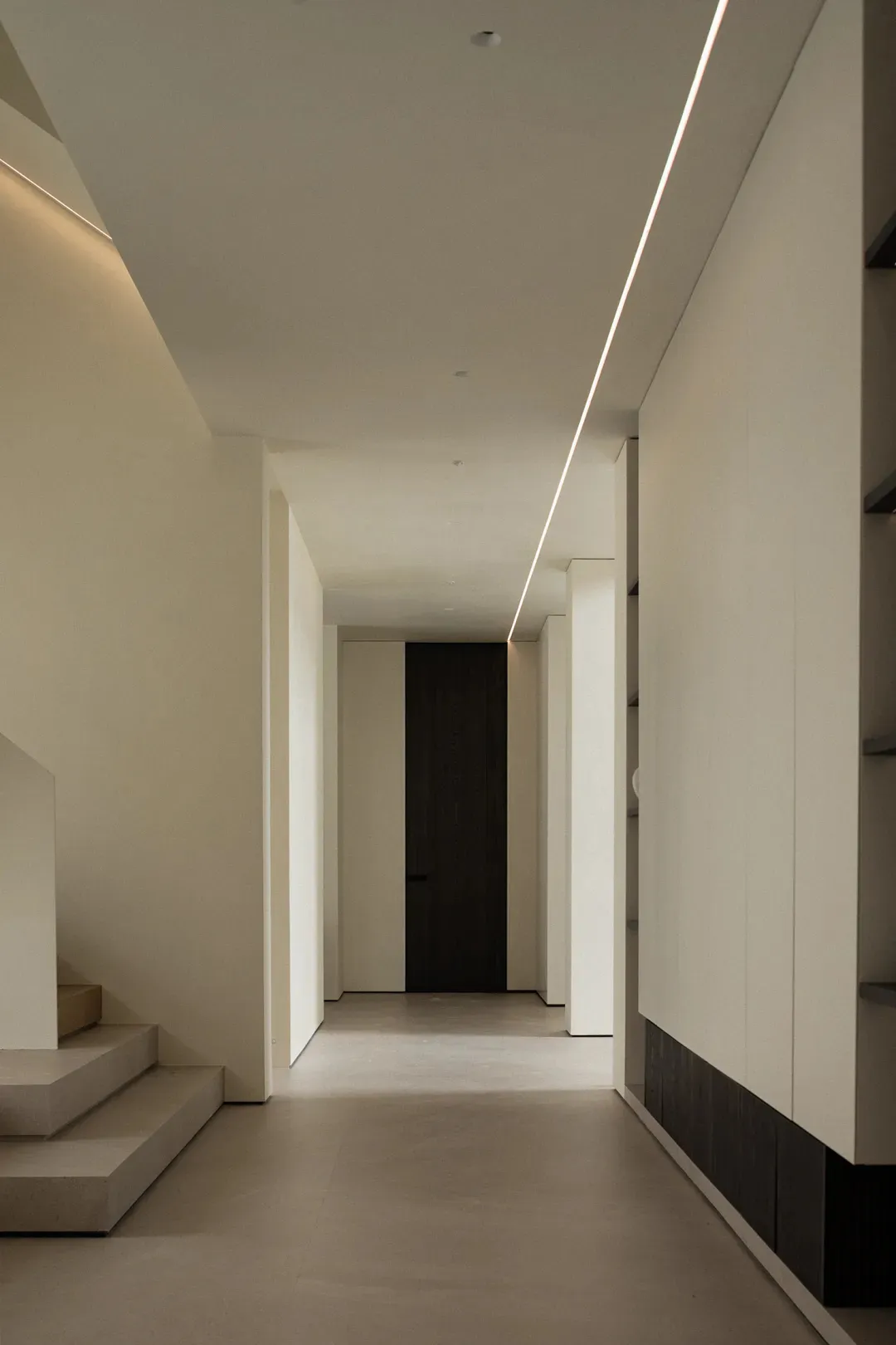 A modern interior space featuring concrete walls and floors.