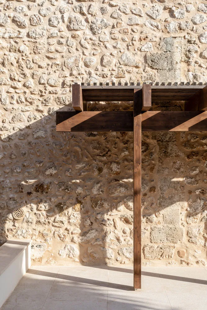 A stone wall with a wooden beam structure attached to it.