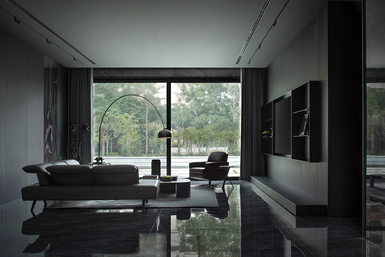 A modern living room with glass windows and a black interior.