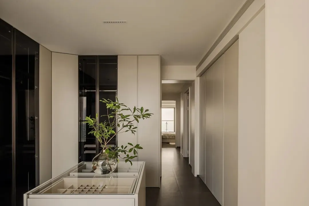 Modern residential interior featuring white walls, wooden flooring, and glass elements.
