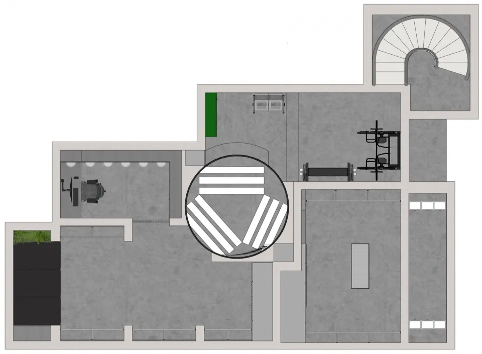 A detailed architectural floor plan of an industrial workspace featuring exposed concrete flooring.