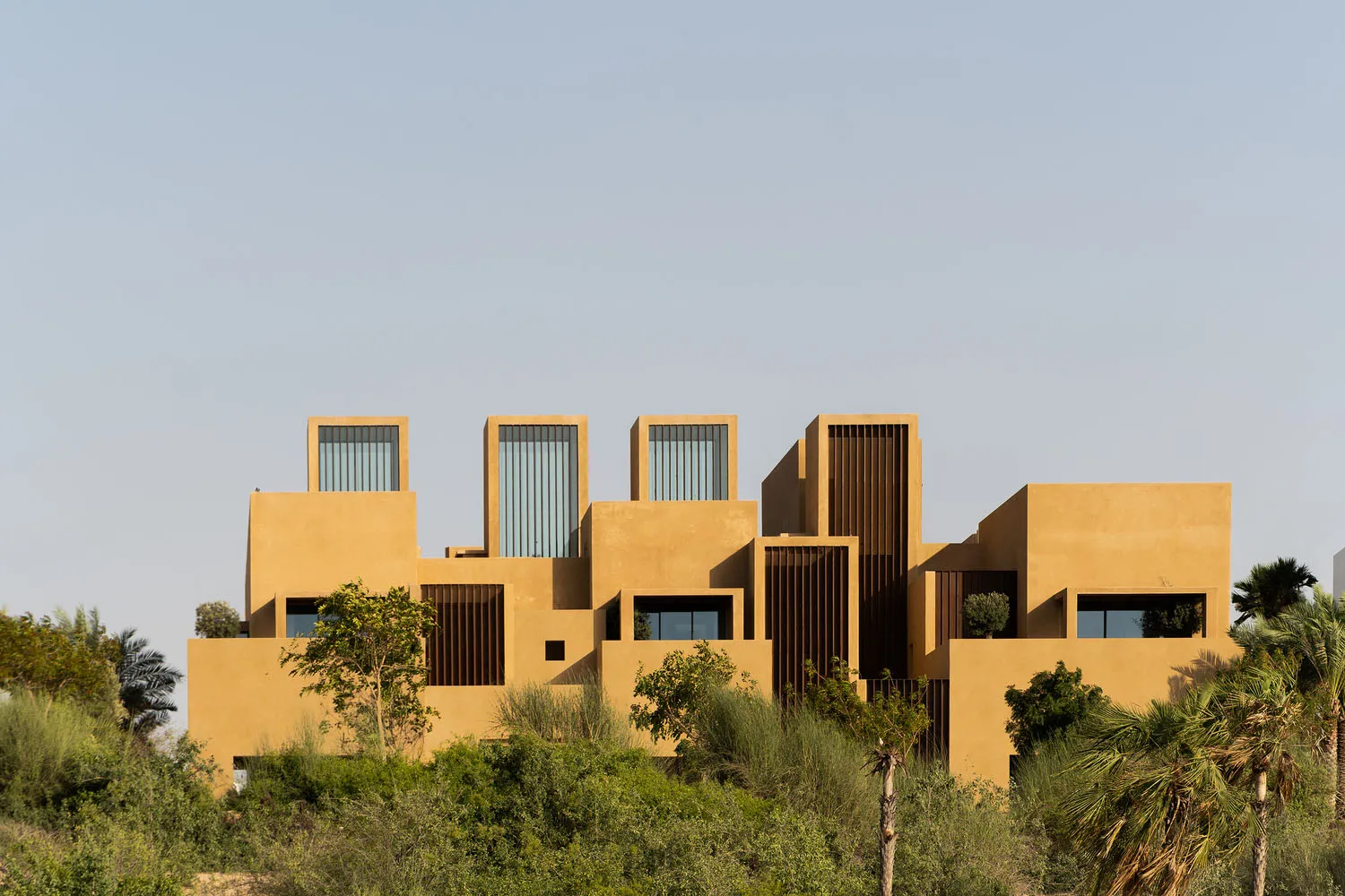 Modern architecture building with sand-colored concrete exteriors and large glass windows.