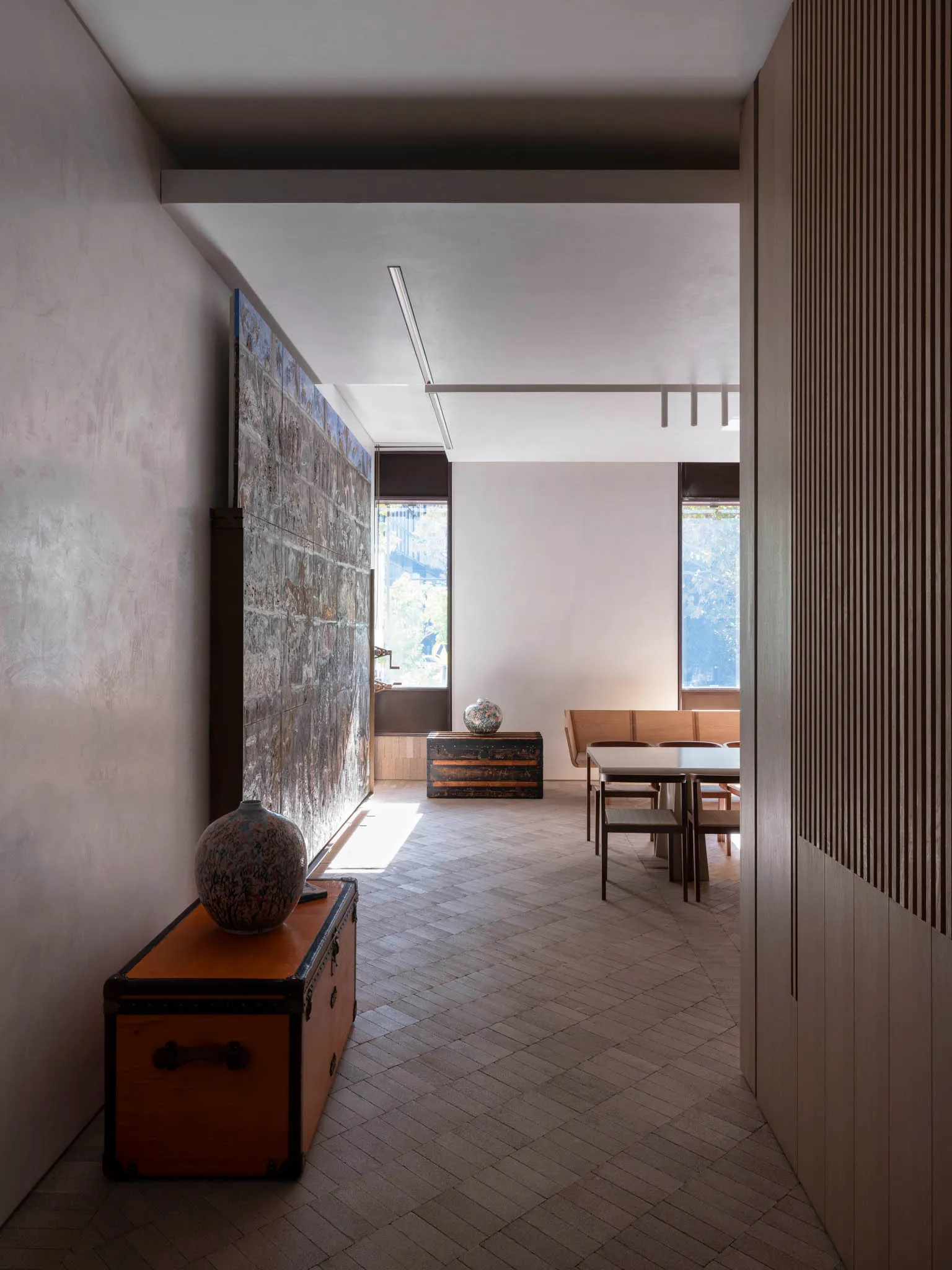 Modern interior design featuring concrete, stone, and wood elements.
