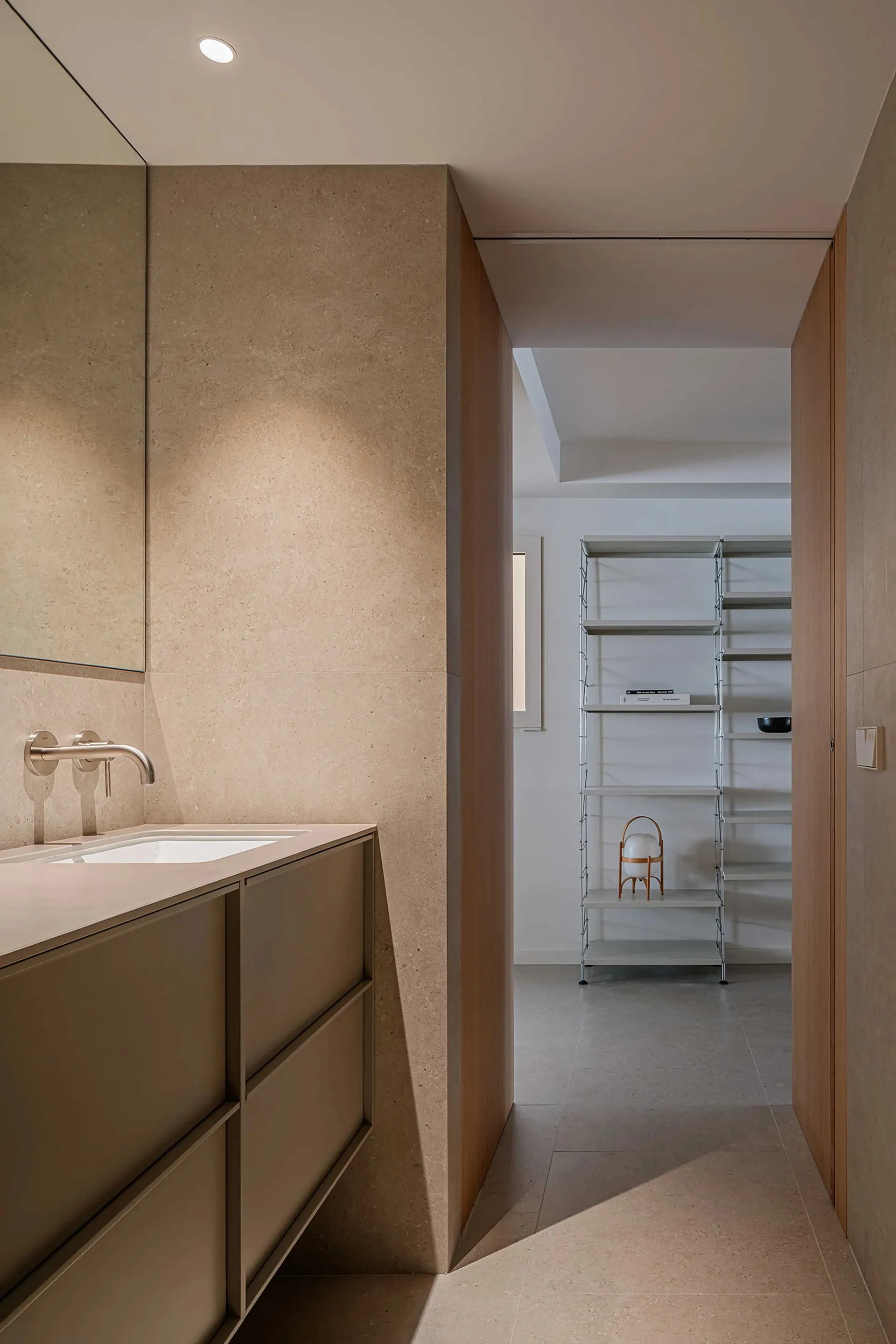 Modern bathroom with concrete walls, minimalist design, and a sleek white sink.