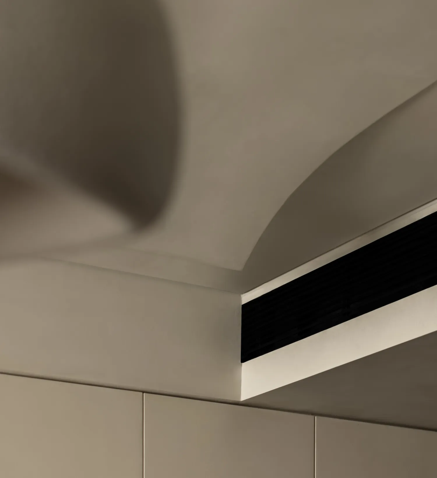 A minimalist interior design featuring a concrete accent wall.