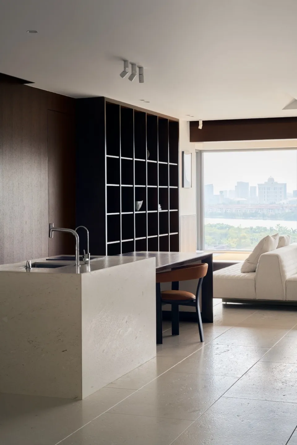 A modern apartment interior featuring a marble countertop and a gray palette.