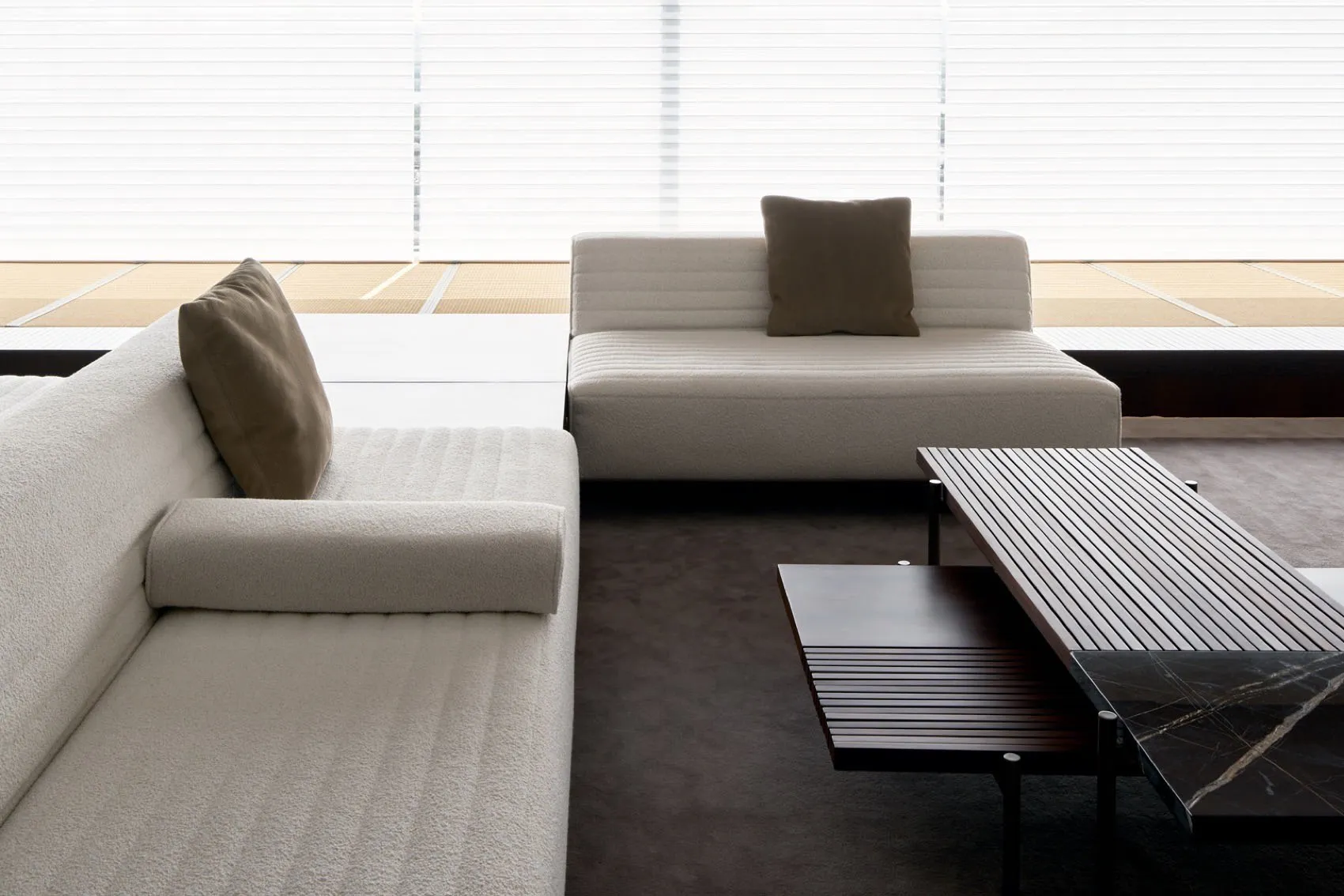 Modern living room featuring white couches and a coffee table.
