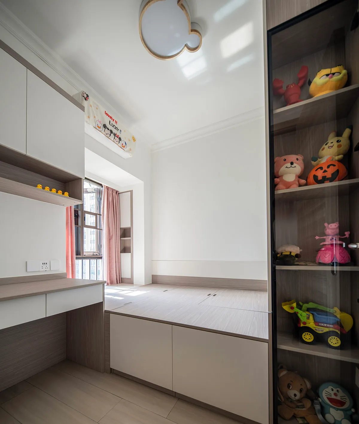 A modern minimalist bedroom with white walls, wooden furniture, and playful toys on shelves.
