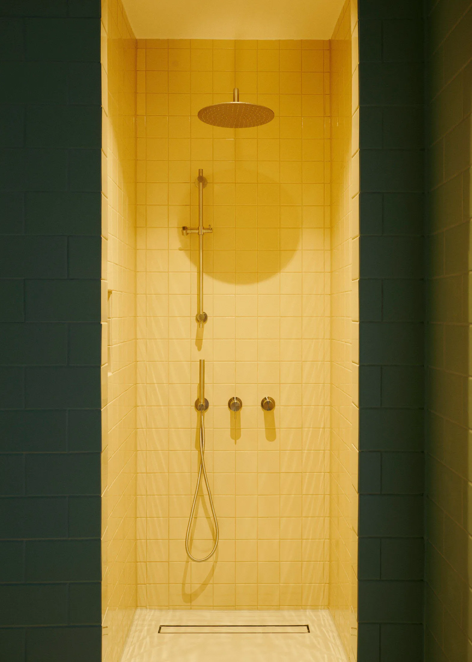 Yellow-tiled minimalist bathroom with modern fixtures.