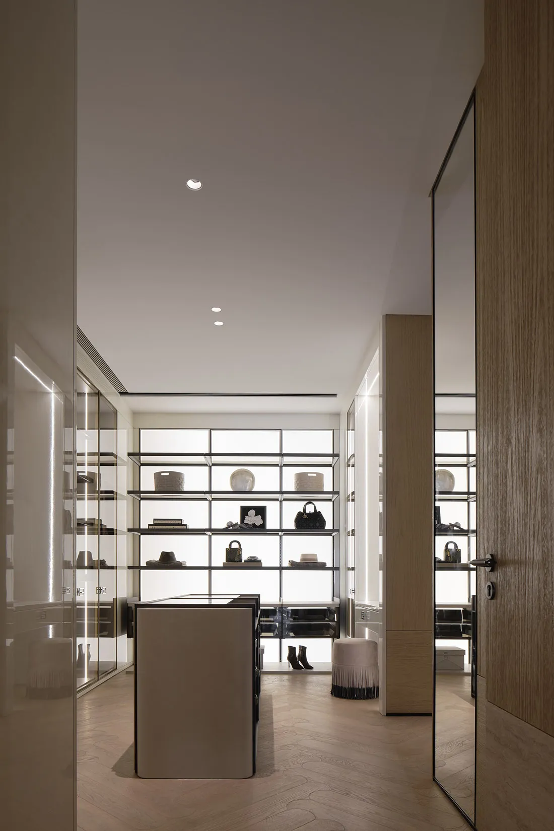 A modern minimalist wardrobe with a sleek, open shelving design.