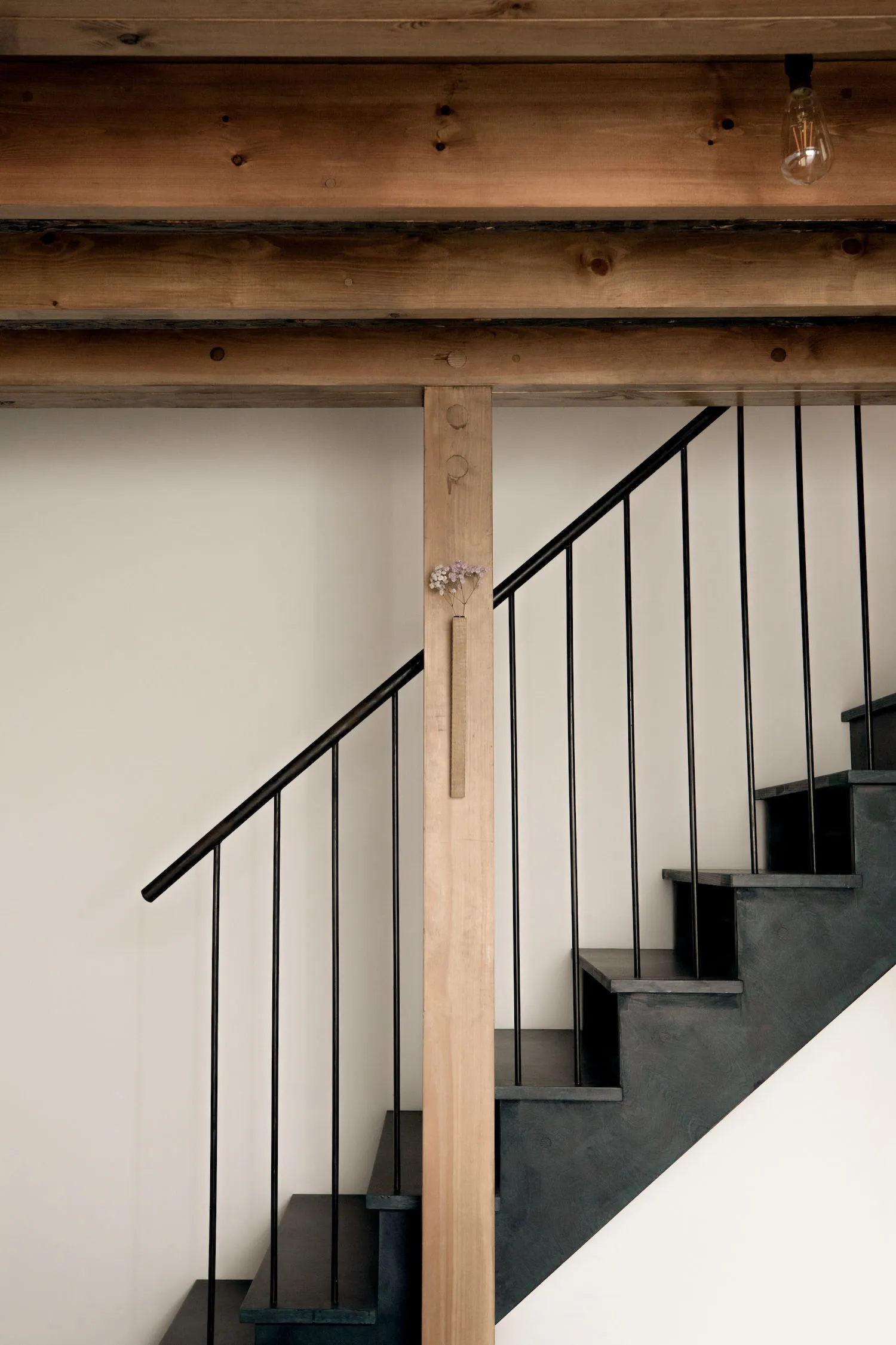 Industrial-style staircase featuring metal railings and wooden steps