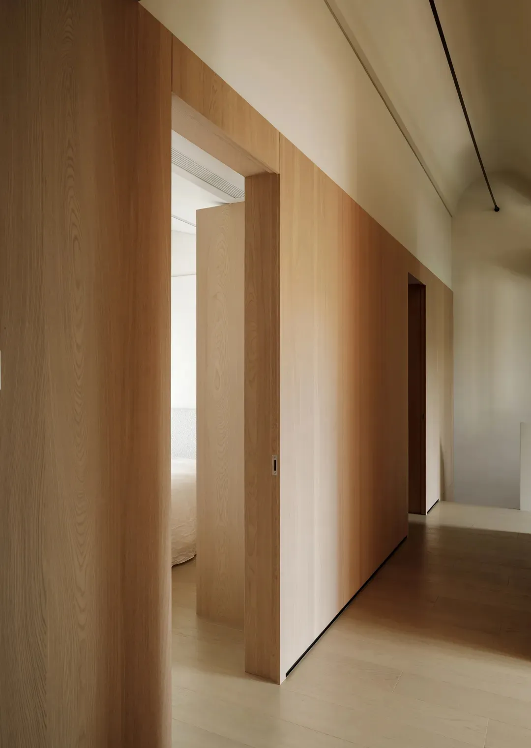 Modern interior design featuring wooden paneling and a minimalist aesthetic.