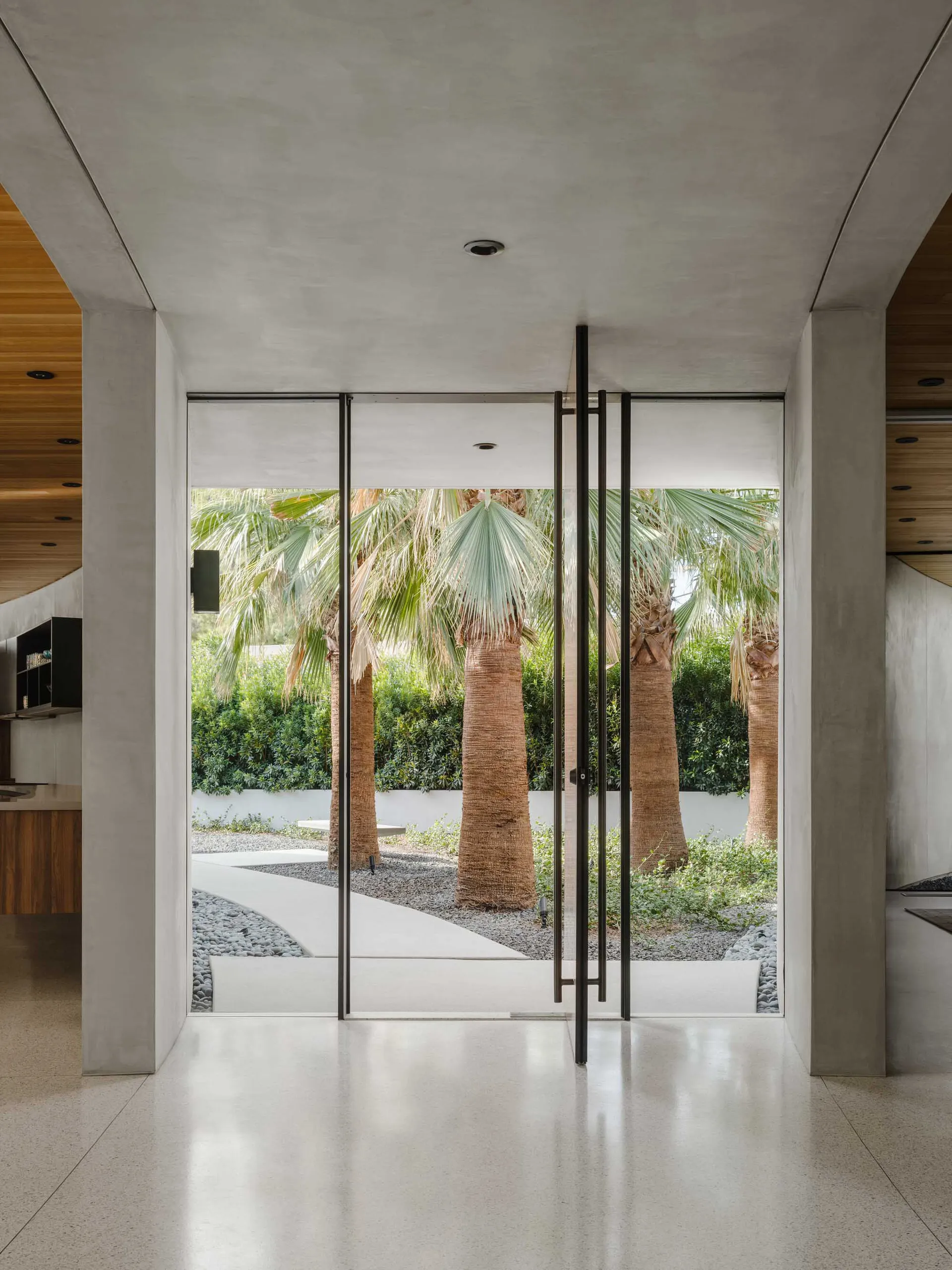 Modern entrance featuring large glass doors and sleek design elements.