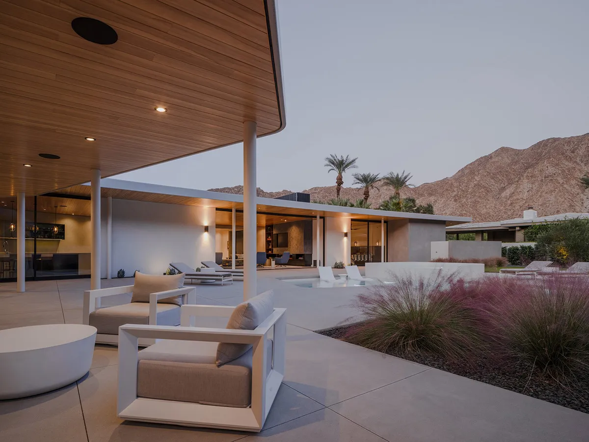 Modern minimalist patio featuring concrete, wood, and glass materials