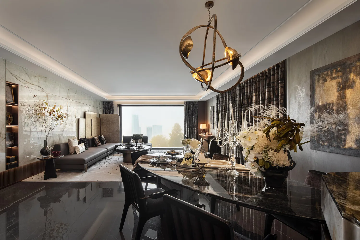 Modern living and dining room featuring marble finishes and glass elements