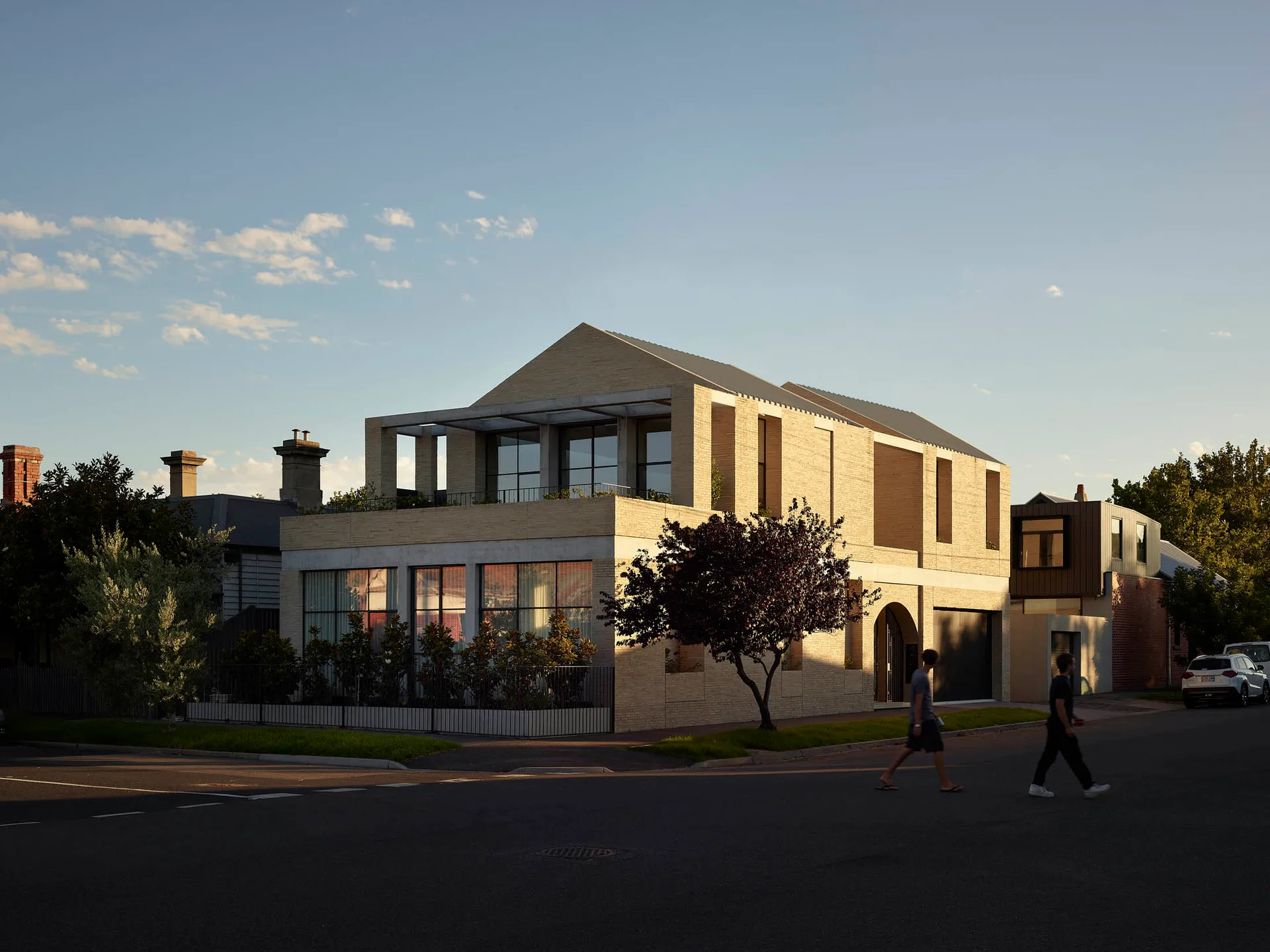 Modern residential house exterior with concrete and brick materials.