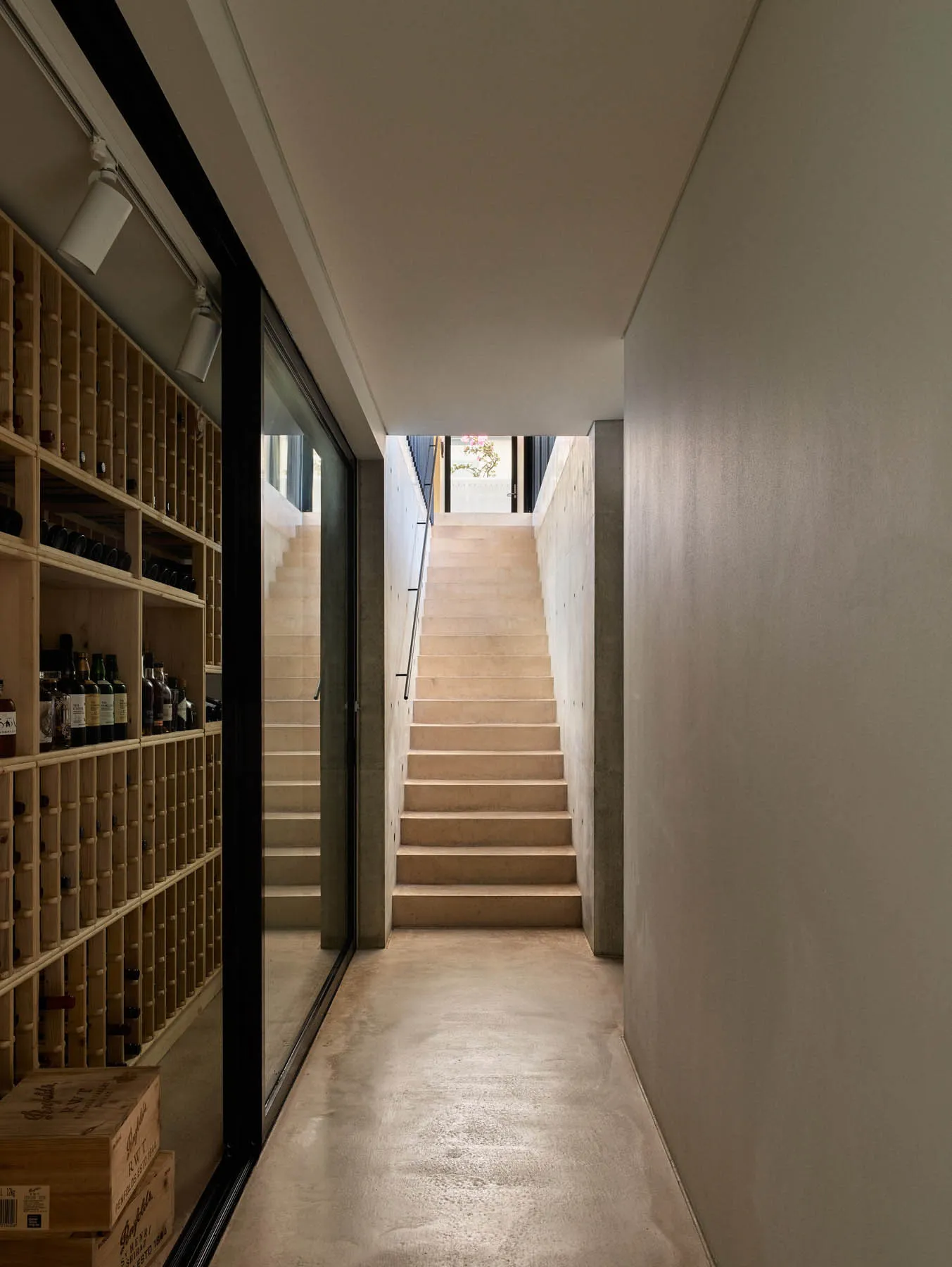 Modern interior space featuring concrete stairs and a library.