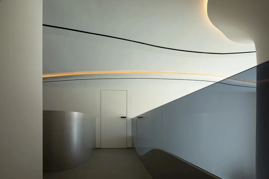 Smooth, curved surfaces made of glass and metal in a minimalist design