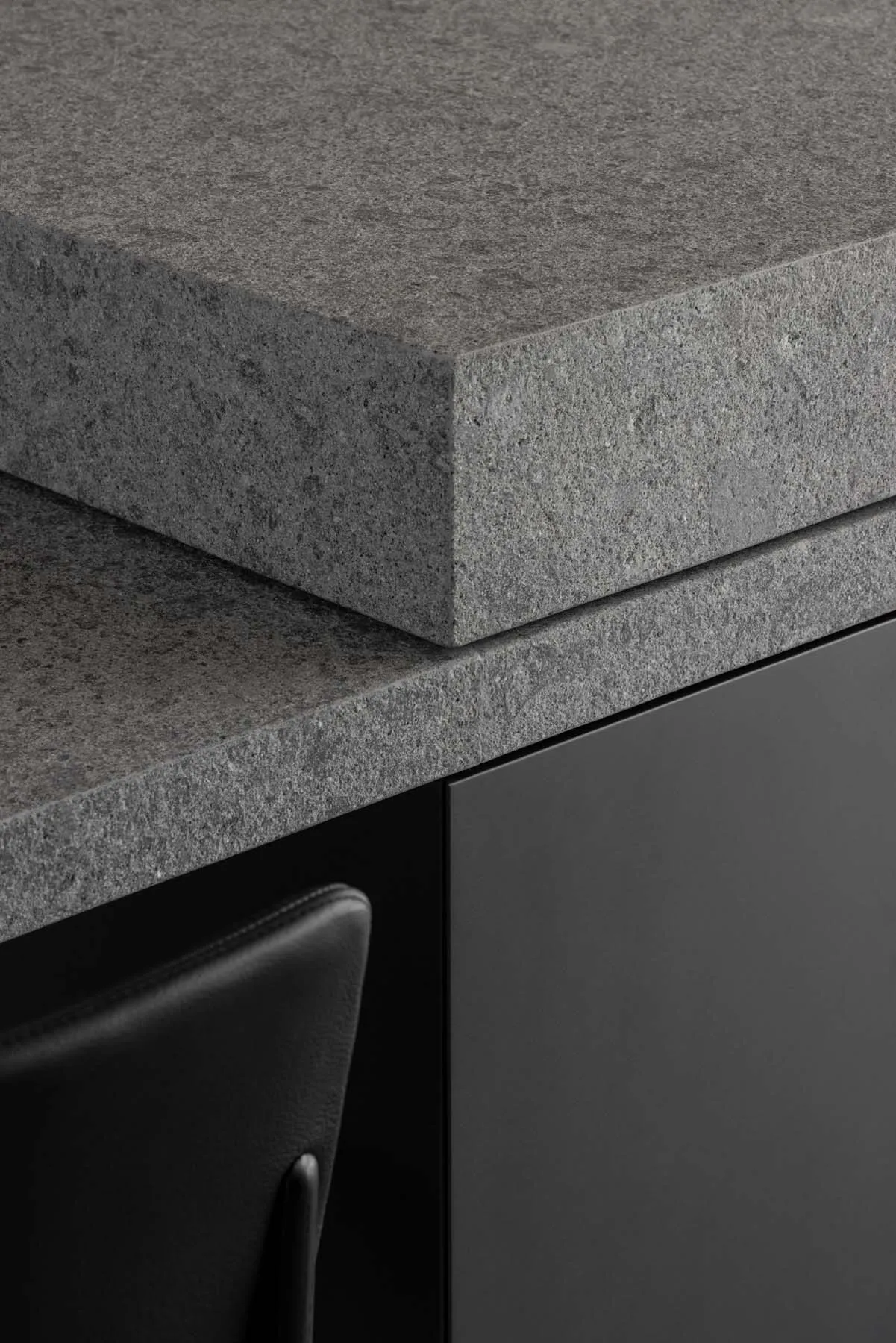 Close-up of a modern kitchen featuring a sleek granite countertop.