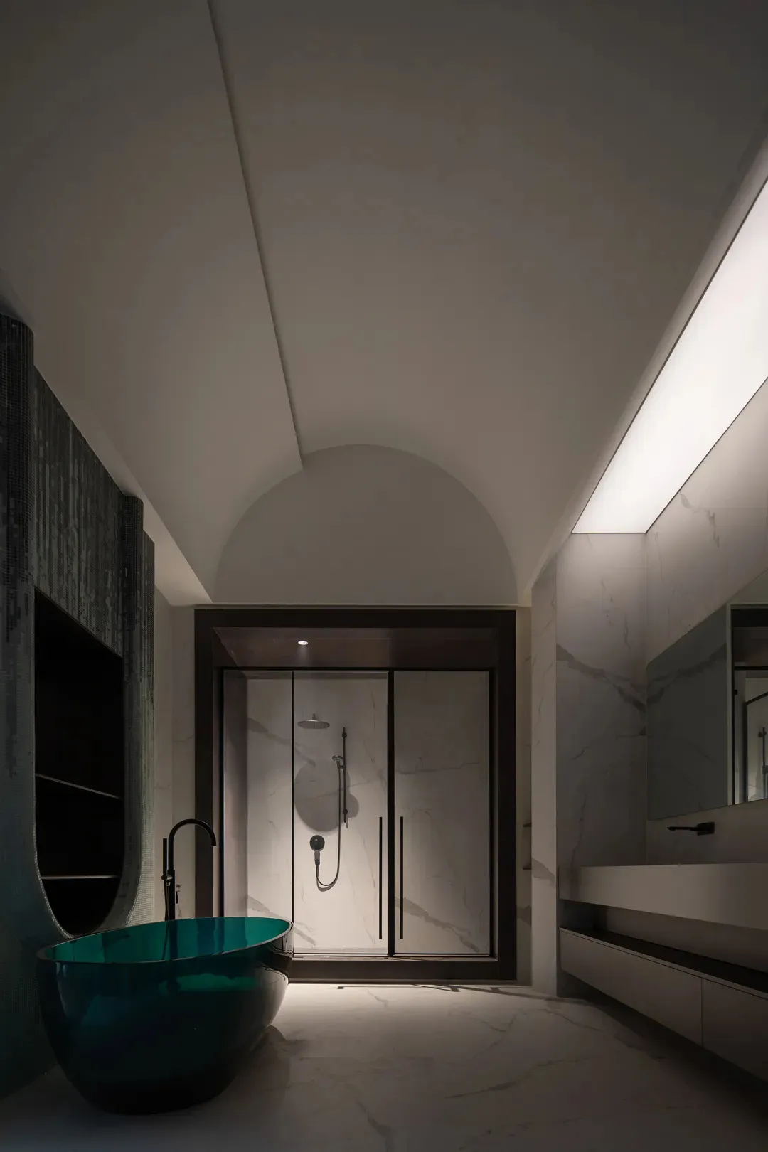 A modern bathroom featuring marble walls and glass shower enclosure.