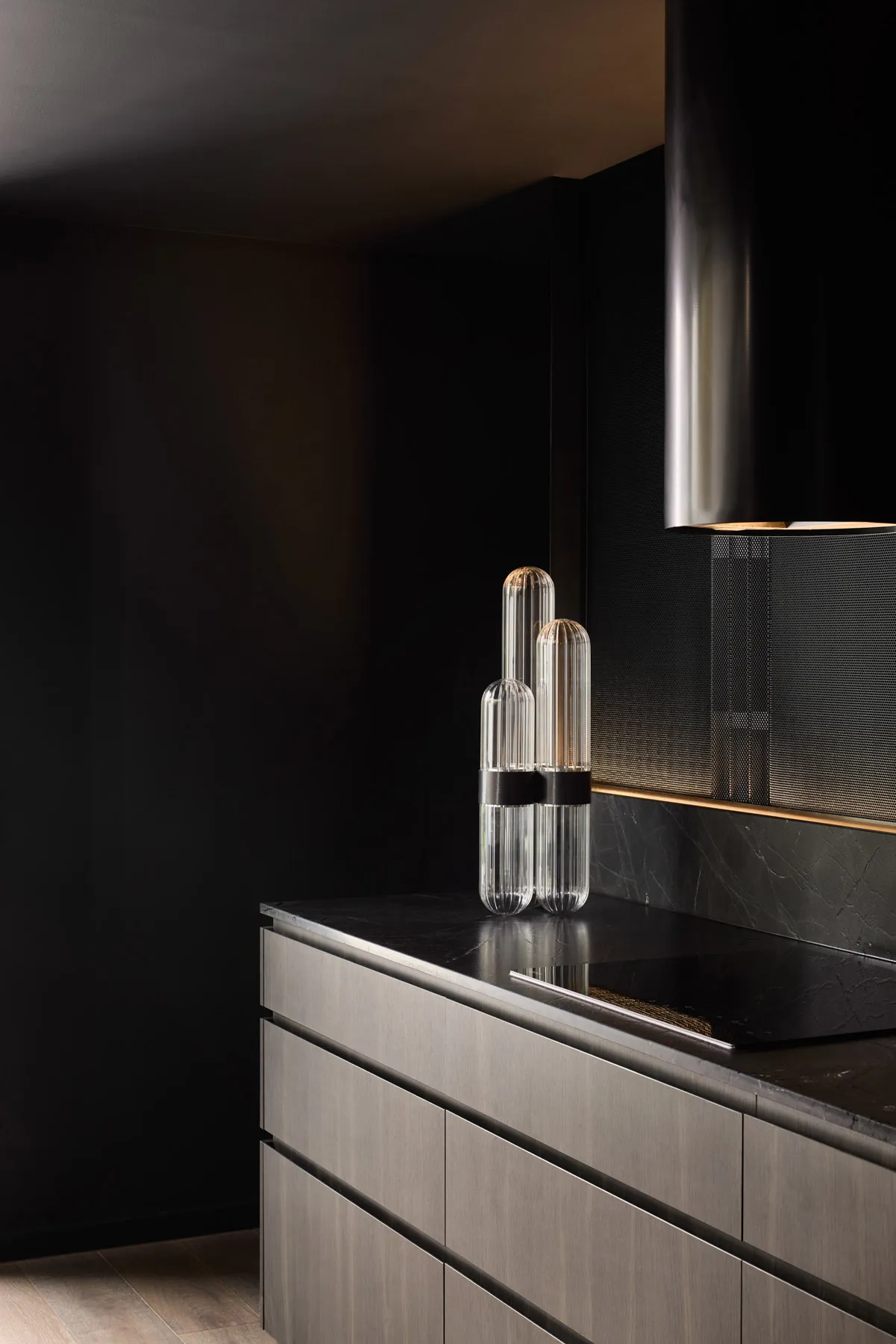Modern kitchen featuring sleek glass and metal elements.
