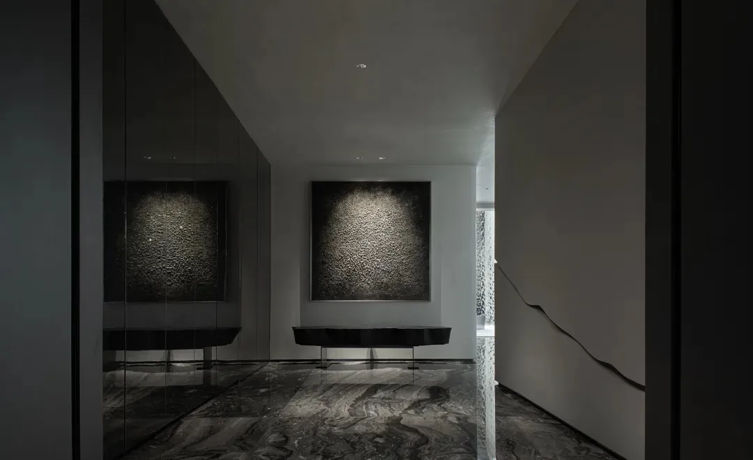 Interior design of a modern minimalist lobby featuring concrete finishes and space.