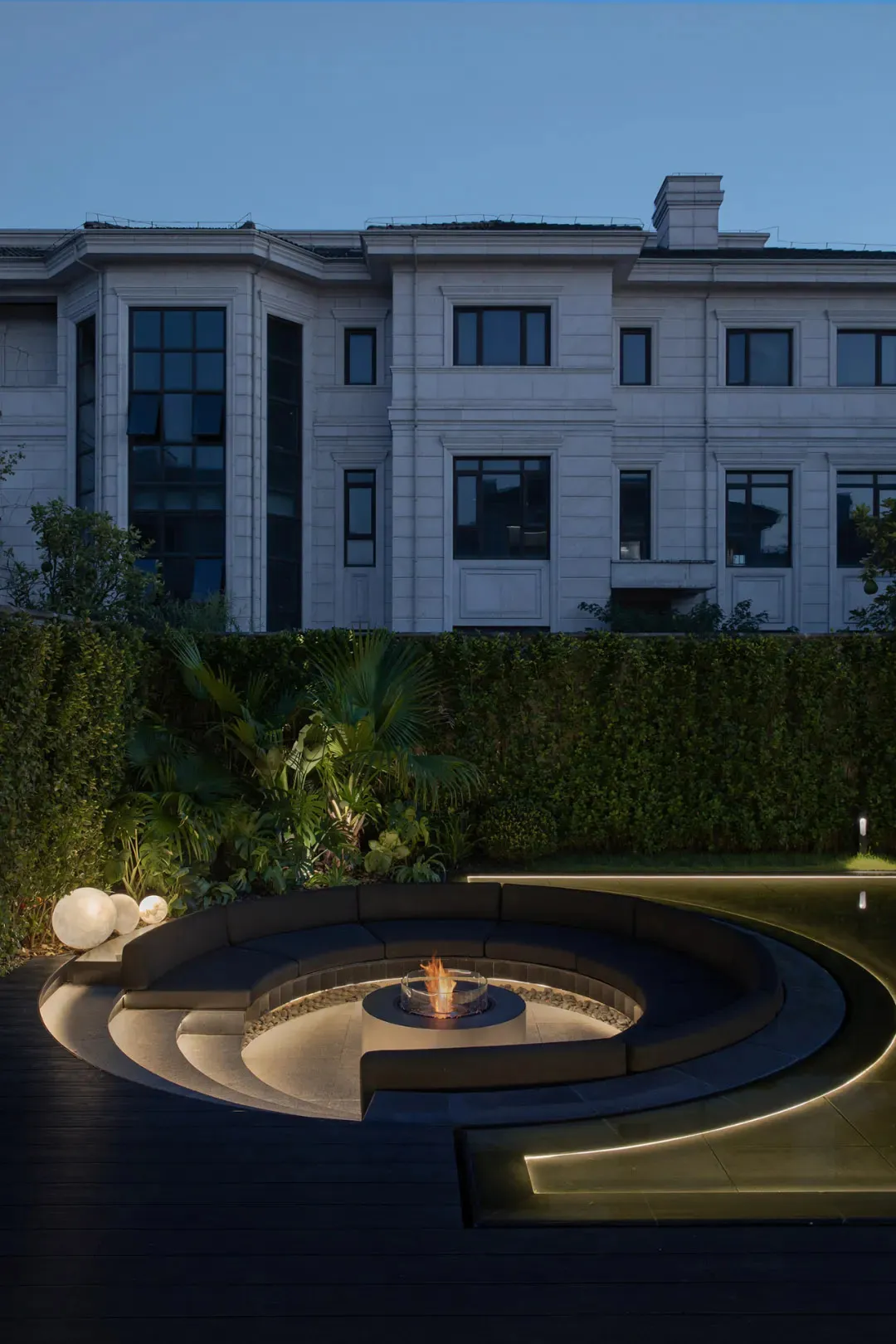 A modern residential patio featuring concrete and glass elements.