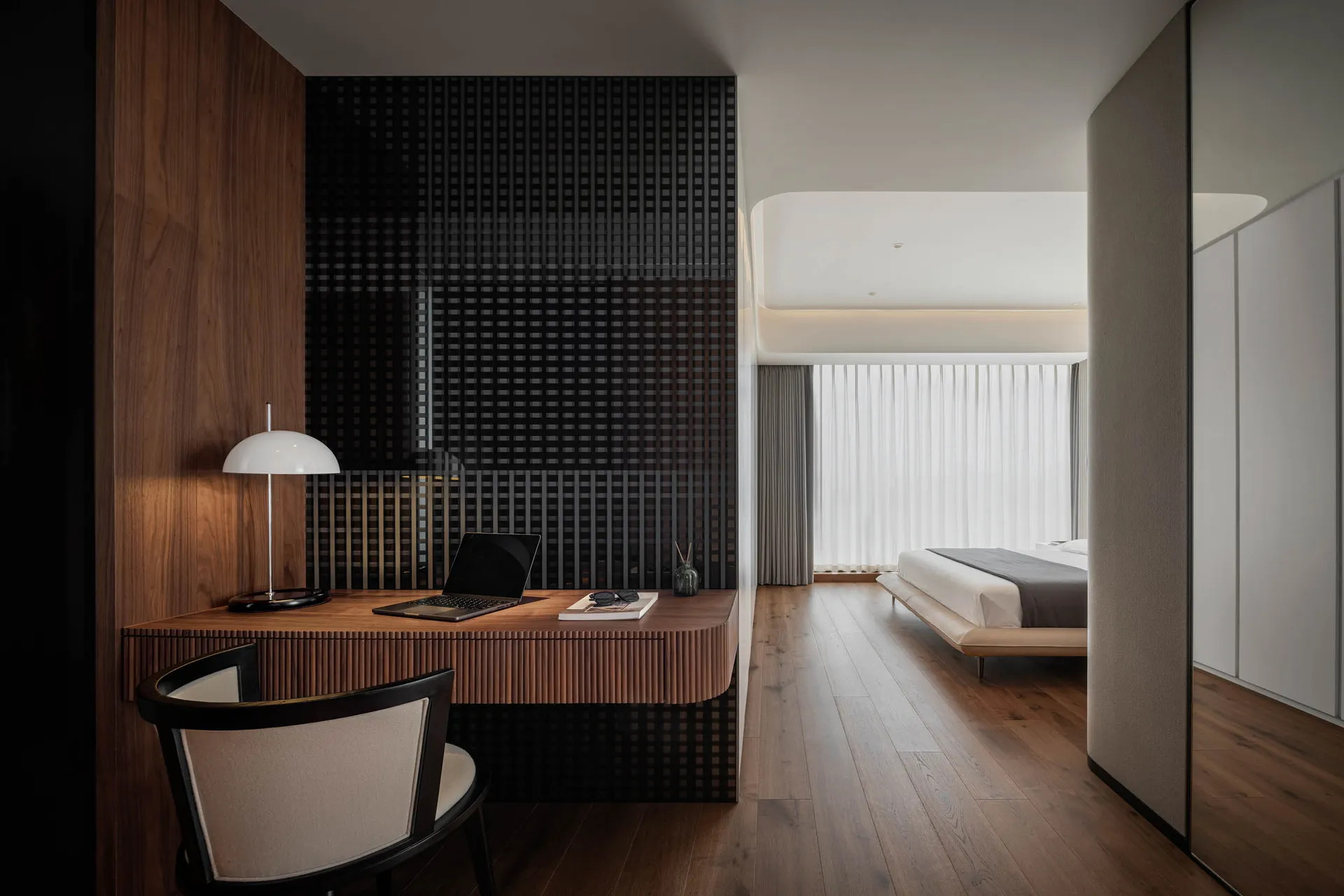 A modern minimalist bedroom with a wooden desk, chair, and floor, featuring a bed with a minimalist design.