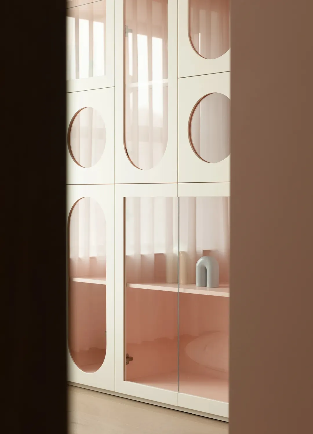 Modern storage cabinet featuring glass doors and shelves.