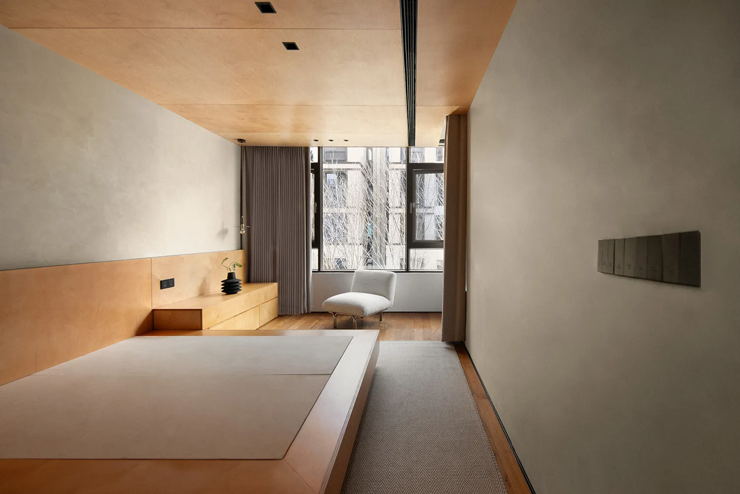 Modern minimalist bedroom featuring a white platform bed with wood accents, minimalistic furniture, and a large window with c