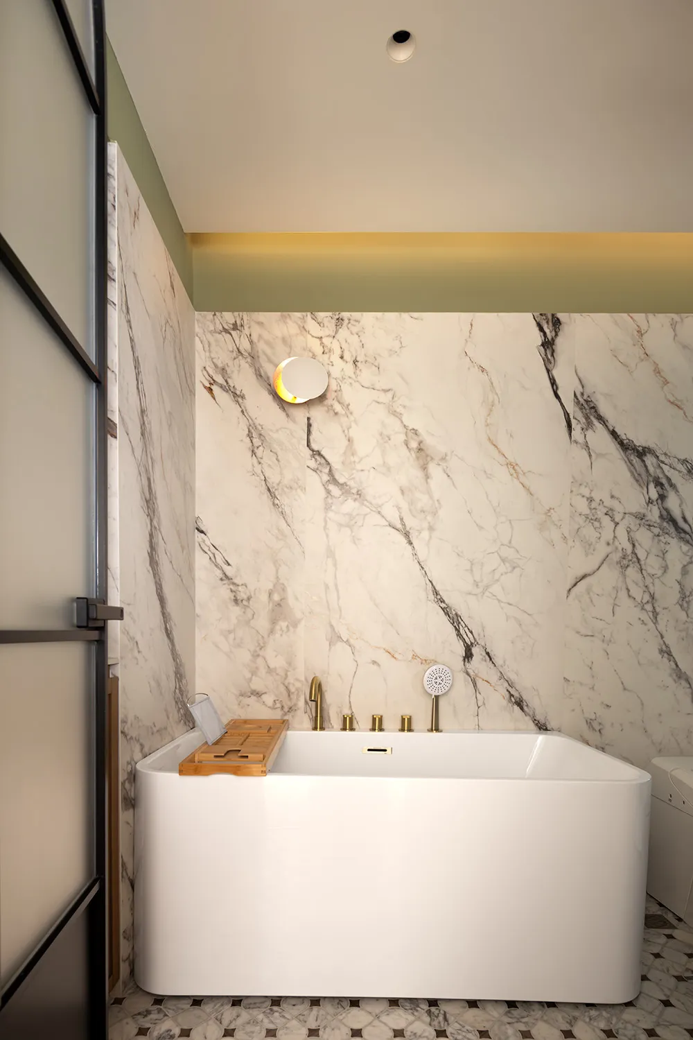 Modern bathroom interior with white marble walls and a freestanding bathtub.