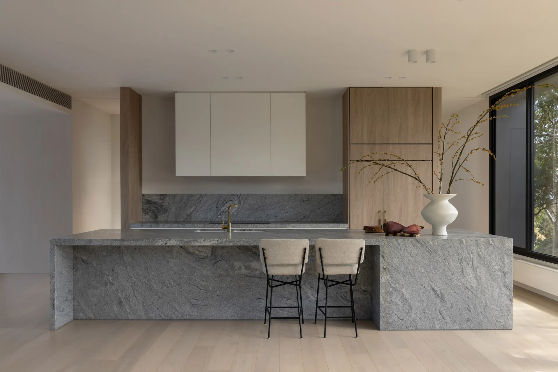 Modern residential kitchen featuring a granite countertop and minimalist design.