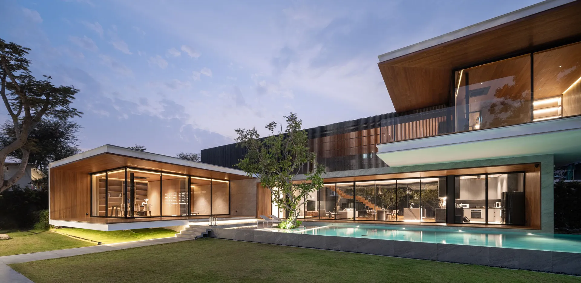 Modern residential house with extensive use of glass materials on the exterior.