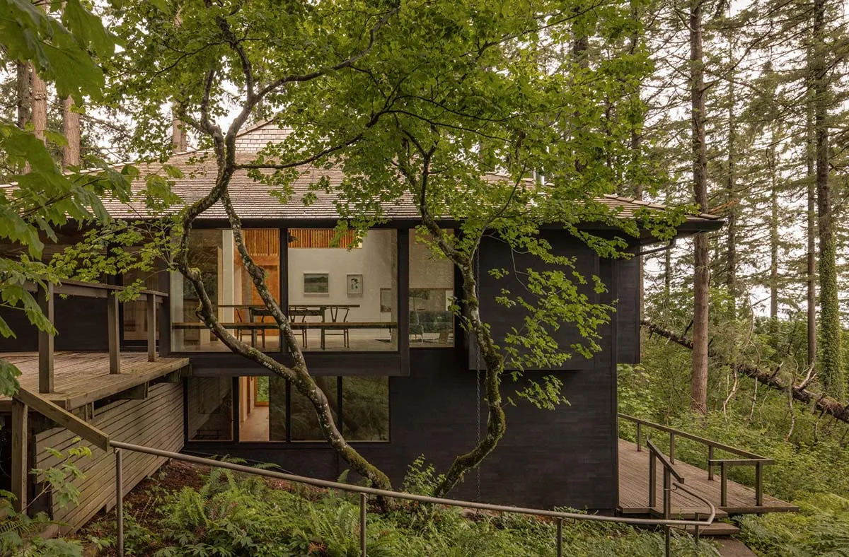 Modern residential architecture featuring wood, glass, and metal materials.