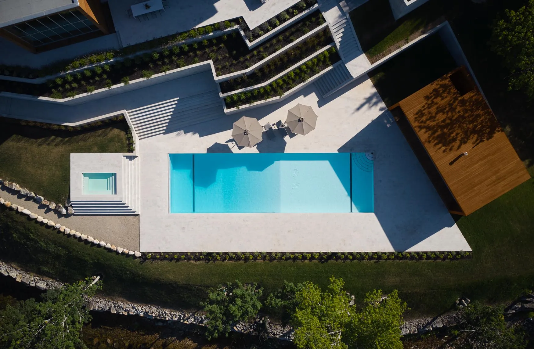 Modern residential pool area with concrete deck and steps