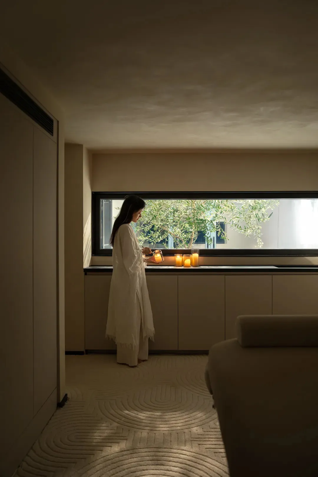 A modern residential interior with textured cloth flooring and minimalistic decor.