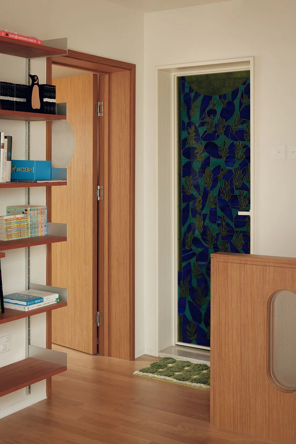 A modern interior featuring a wooden door adorned with decorative tiles.