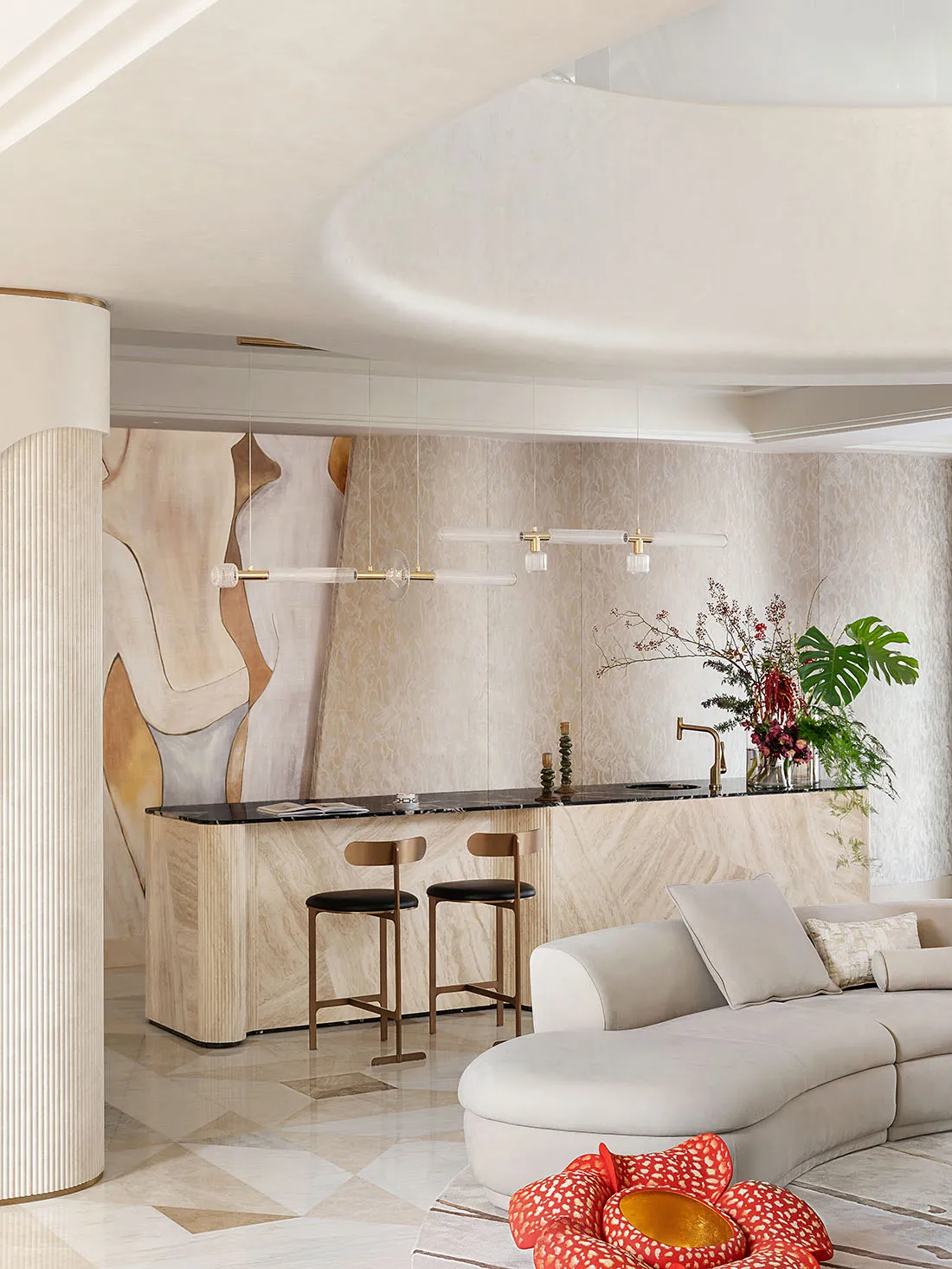 Modern residential interior with marble kitchen island and light wood furnishings.