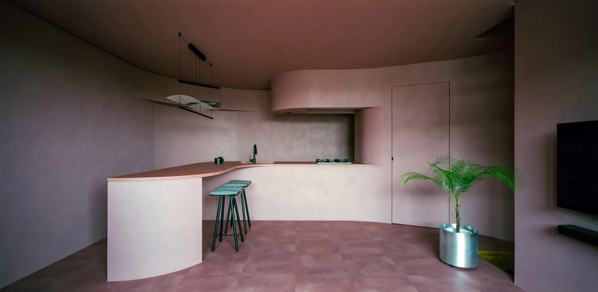 Modern kitchen with concrete terrazzo countertops and minimalist design.