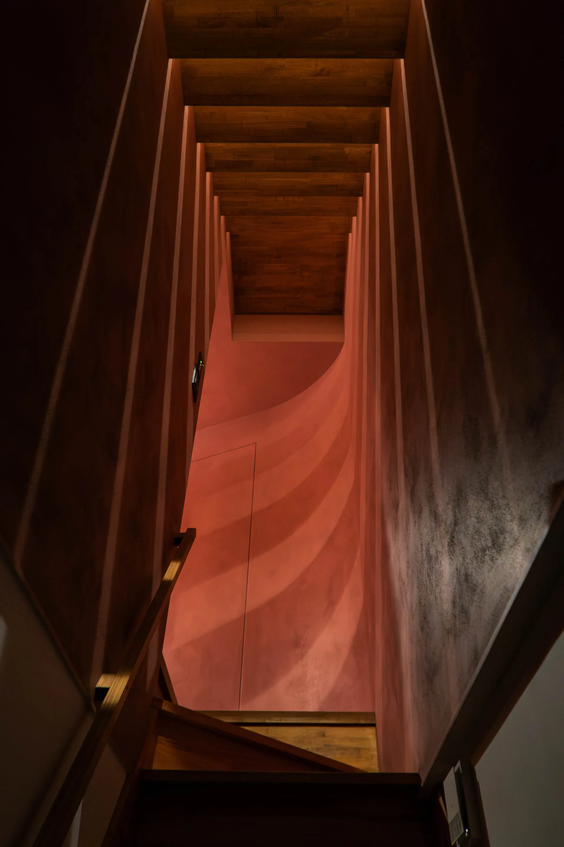 A modern interior design featuring a striking red wall.