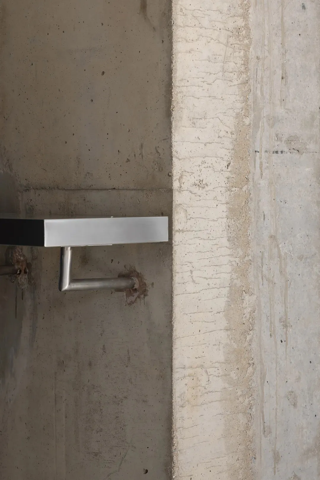 Concrete wall and floor details with minimalist design features.